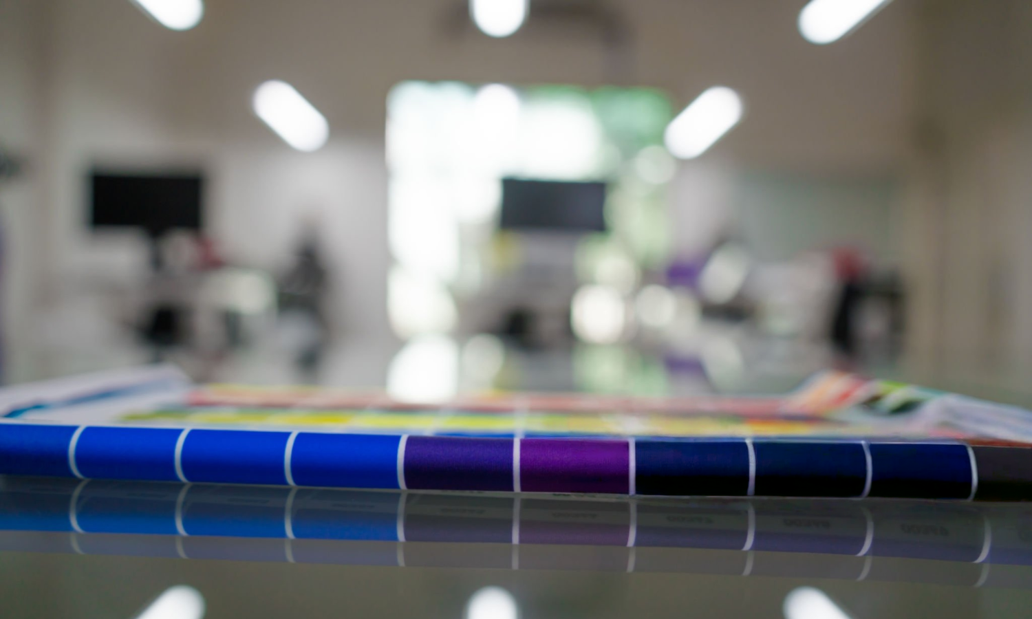 Color film laboratory with technicians testing and developing new automotive wrap colors